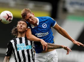 Newcastle United's Irish midfielder Jeff Hendrick (L) jumps for a header with Brighton's English defender Dan Burn during the English Premier League football match between Newcastle United and Brighton and Hove Albion at St James' Park in Newcastle upon Tyne, north-east England on September 20, 2020 (Photo by LEE SMITH/POOL/AFP via Getty Images)