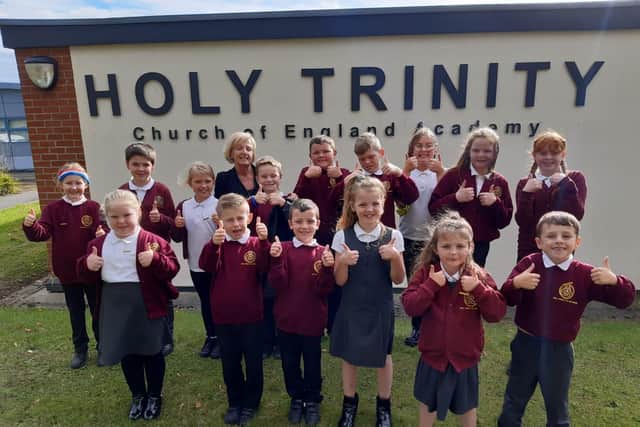 Headteacher Tina Murphy alongside pupils from Holy Trinity Church of England Academy.