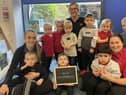 Nursery manager, Vicky Rounthwaite (centre), Ava Elliott, apprentice practitioner (left), and Courtney Gibb, deputy manager (right) celebrating the nursery's outstanding Ofsted judgement with the children.