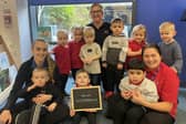 Nursery manager, Vicky Rounthwaite (centre), Ava Elliott, apprentice practitioner (left), and Courtney Gibb, deputy manager (right) celebrating the nursery's outstanding Ofsted judgement with the children.