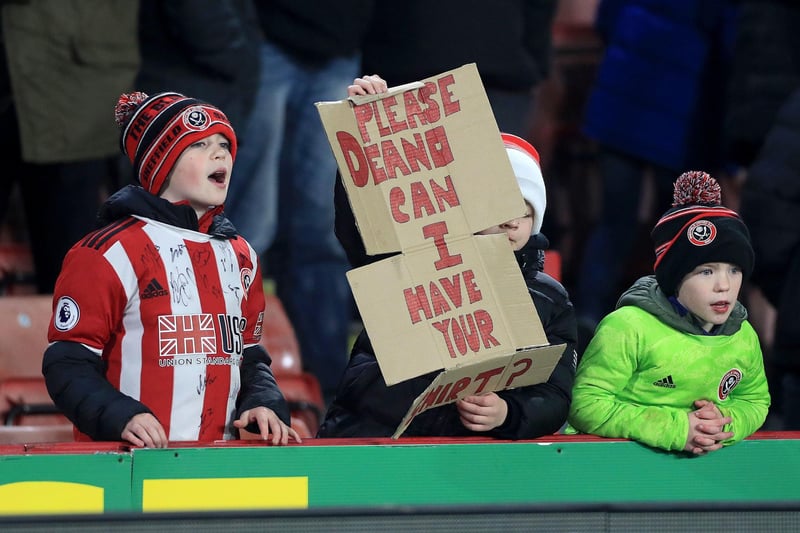Young Sheffield United fans hold up a sign asking for Dean Henderson's shirt