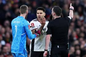 MANCHESTER, ENGLAND - MARCH 19: Aleksandar Mitrovic of Fulham receives a red card from Referee Chris Kavanagh during the Emirates FA Cup Quarter Final match between Manchester United and Fulham at Old Trafford on March 19, 2023 in Manchester, England.  (Photo by Clive Brunskill/Getty Images)