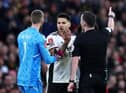 MANCHESTER, ENGLAND - MARCH 19: Aleksandar Mitrovic of Fulham receives a red card from Referee Chris Kavanagh during the Emirates FA Cup Quarter Final match between Manchester United and Fulham at Old Trafford on March 19, 2023 in Manchester, England.  (Photo by Clive Brunskill/Getty Images)