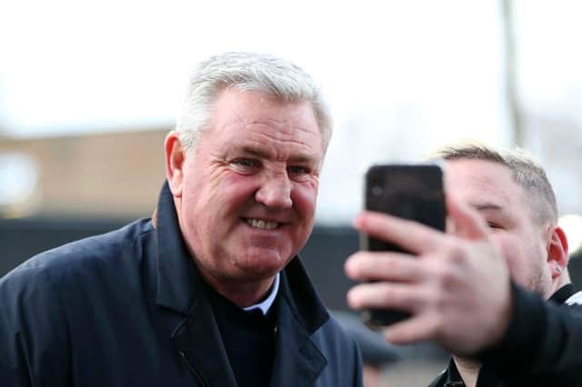 BURNLEY, ENGLAND - DECEMBER 14: Steve Bruce, Manager of Newcastle United poses for a selfie with a fan during the Premier League match between Burnley FC and Newcastle United at Turf Moor on December 14, 2019 in Burnley, United Kingdom.