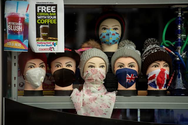 Face masks on display in a shop ahead of new guidelines coming into force on Saturday, August 8. Picture: Photo by OLI SCARFF/AFP via Getty Images.