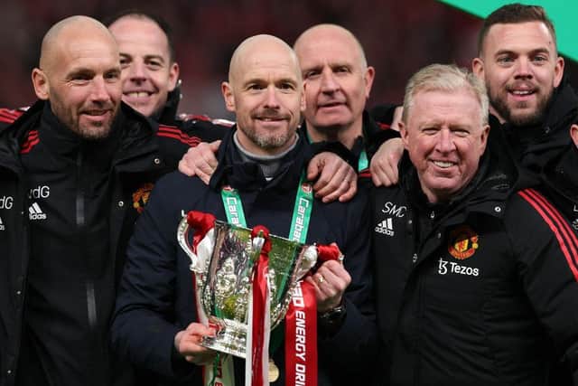 Erik ten Hag (C), Manager of Manchester United, Assistant Managers, Mitchell van der Gaag (L) and Steve McClaren celebrate with the Carabao Cup trophy following victory in the Carabao Cup Final match between Manchester United and Newcastle United at Wembley Stadium on February 26, 2023 in London, England. (Photo by Julian Finney/Getty Images)