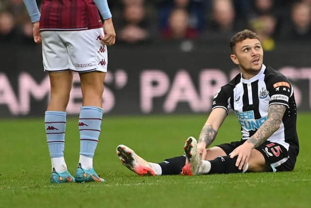 Newcastle full back Kieran Trippier sits down on the turf before leaving the field with an injury during the Premier League match between Newcastle United and Aston Villa at St. James Park on February 13, 2022 in Newcastle upon Tyne, England. (Photo by Stu Forster/Getty Images)