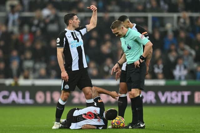 Newcastle United's English striker Callum Wilson lies injured during the English Premier League football match between Newcastle United and Manchester United at St James' Park (Photo by PAUL ELLIS/AFP via Getty Images)
