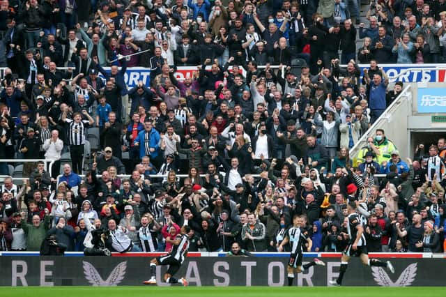 NEWCASTLE UPON TYNE, ENGLAND - AUGUST 15: Fans of Newcastle United celebrate their side's first goal scored by Callum Wilson of Newcastle United during the Premier League match between Newcastle United  and  West Ham United at St. James Park on August 15, 2021 in Newcastle upon Tyne, England. (Photo by George Wood/Getty Images)