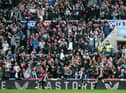 NEWCASTLE UPON TYNE, ENGLAND - AUGUST 15: Fans of Newcastle United celebrate their side's first goal scored by Callum Wilson of Newcastle United during the Premier League match between Newcastle United  and  West Ham United at St. James Park on August 15, 2021 in Newcastle upon Tyne, England. (Photo by George Wood/Getty Images)