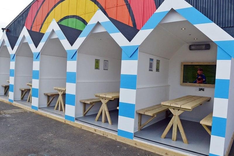 These beach huts were recently unveiled in the beer garden of where?