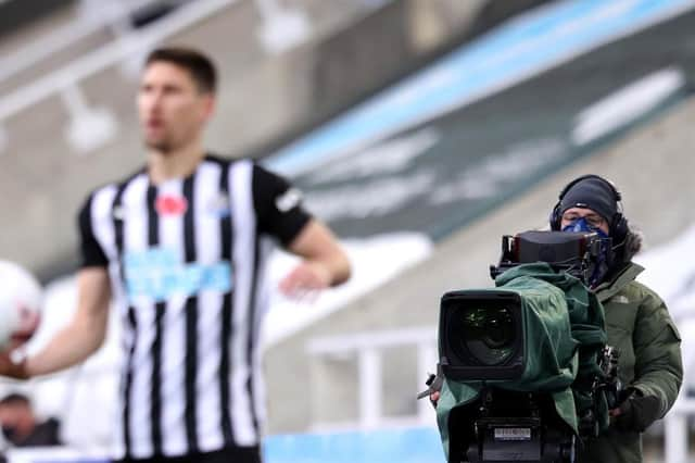 A TV cameraman films during the Premier League match between Newcastle United and Everton.