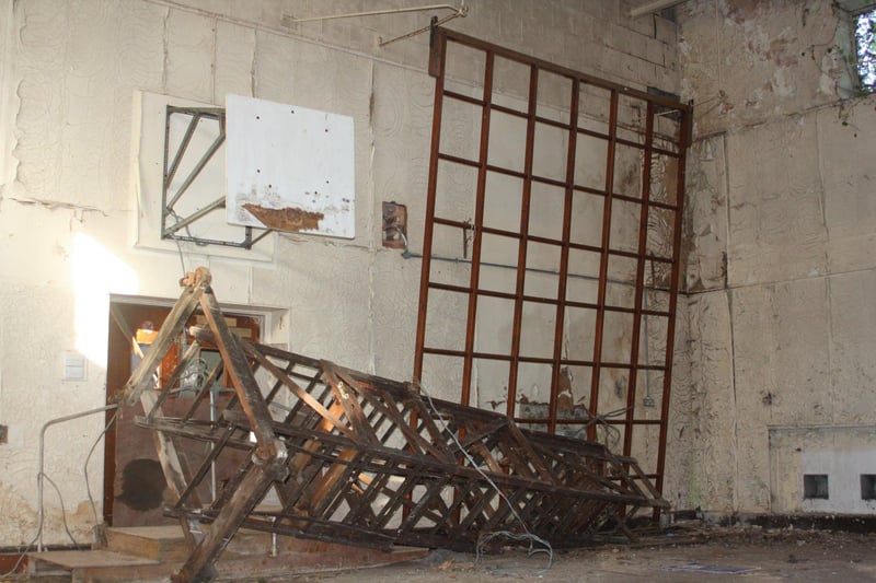 A climbing frame and basketball net is all that remains of the gymnasium.