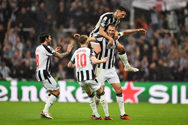 Dan Burn celebrates with his Newcastle teammates after VAR rules his goal should stand. (Photo by Michael Regan/Getty Images)