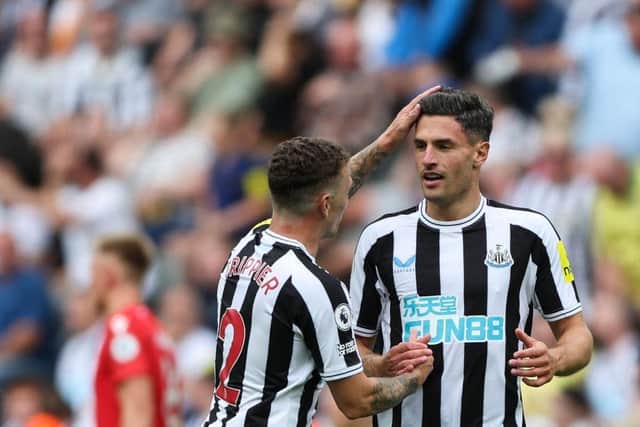 Newcastle United's Swiss defender Fabian Schar (R) celebrates with Newcastle United's English defender Kieran Trippier (L) after scoring his team first goal during the English Premier League football match between Newcastle United and Nottingham Forest at St James' Park in Newcastle-upon-Tyne, north east England on August 6, 2022. (Photo by NIGEL RODDIS/AFP via Getty Images)