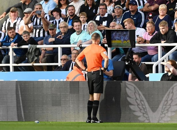 <p>Referee Jarred Gillett checks the VAR screen of the red card given to Kieran Trippier of Newcastle United which is overturned to a yellow card during the Premier League match between Newcastle United and Manchester City at St. James Park on August 21, 2022 in Newcastle upon Tyne, England. (Photo by Stu Forster/Getty Images)</p>