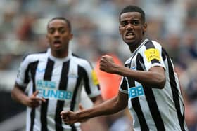 Newcastle United's Swedish striker Alexander Isak (R) celebrates scoring the team's fifth goal during the English Premier League football match between Newcastle United and Tottenham Hotspur at St James' Park in Newcastle-upon-Tyne, north east England on April 23, 2023. (Photo by Lindsey Parnaby / AFP)