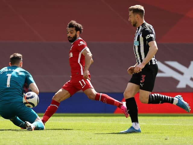 Newcastle United's Slovakian goalkeeper Martin Dubravka (L) saves a shot from Liverpool's Egyptian midfielder Mohamed Salah (C) during the English Premier League football match between Liverpool and Newcastle United at Anfield in Liverpool, north west England on April 24, 2021.