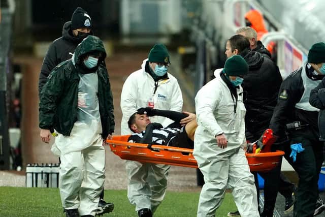 Fabian Schar of Newcastle United goes off injured on a stretcher during the Premier League match between Newcastle United and Southampton at St. James Park on February 06, 2021 (Photo by Owen Humphreys - Pool/Getty Images)