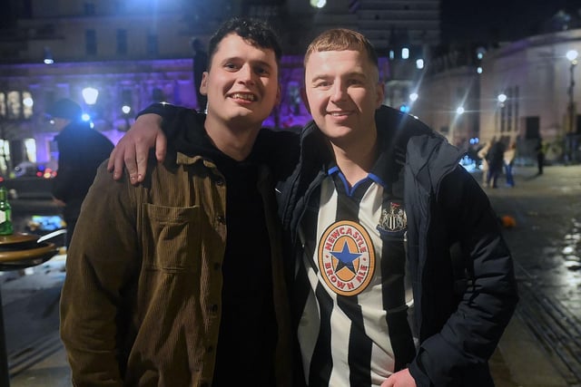 Two happy Newcastle fans pose for a photo