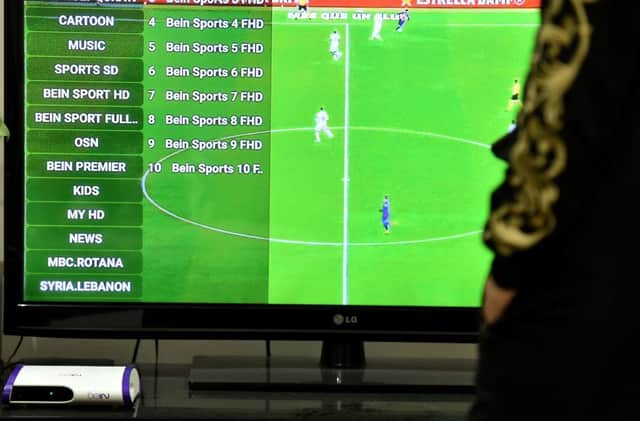 A picture taken January 20, 2020, shows family members browsing Qatar's beIN sport channel at their home in the Saudi capital Riyadh. - Subscribing to Qatar's beIN Sports, the Arab world's leading sports channel which has exclusive rights to Spain's LaLiga and other key tournaments, has become extremely difficult for Saudi fans since the kingdom's 2017 boycott of Qatar. Just days after Riyadh and its allies cut ties, it banned the sale and distribution of beIN receivers, and blocked Qatari websites as well as all transactions with its former ally. (Photo by FAYEZ NURELDINE / AFP)