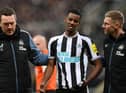 Newcastle United's Alexander Isak leaves the pitch after taking the ball to the head.