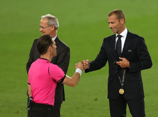 COLOGNE, GERMANY - AUGUST 21: Aleksander Ceferin, President of UEFA fist bumps with Match Referee, Danny Makkelie following the UEFA Europa League Final between Seville and FC Internazionale at RheinEnergieStadion on August 21, 2020 in Cologne, Germany. (Photo by Lars Baron/Getty Images)