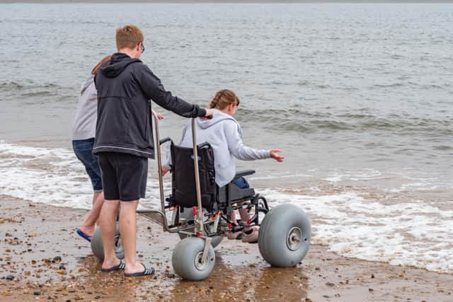 Thomas, Kelly and Hannah Lawton used one of the chairs to see what it was like when down on the sand at Roker.