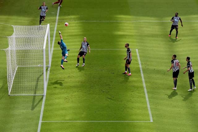NEWCASTLE UPON TYNE, ENGLAND - JULY 26: Virgil van Dijk of Liverpool scores his team's first goal from a header past goalkeeper Martin Dubravka of Newcastle United to make score 1-1 during the Premier League match between Newcastle United and Liverpool FC at St. James Park on July 26, 2020 in Newcastle upon Tyne, England.