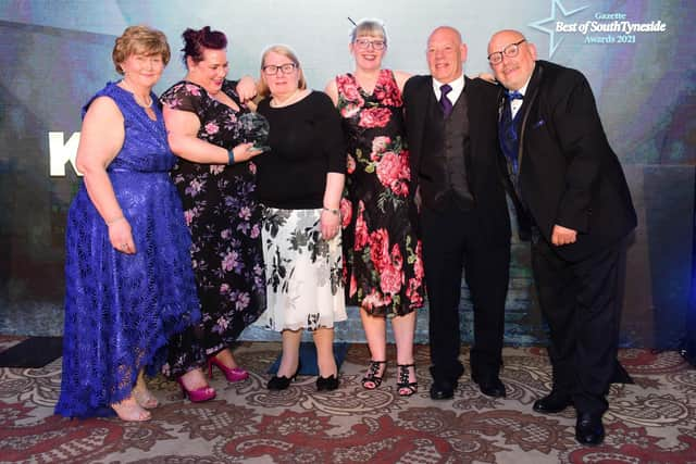 Councilllor Tracey Dixon (left) presents the posthumous award to the family of Karen Ratcliffe, with awards host Ray Spencer (right) also pictured, right.