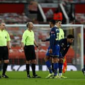 Kayne Ramsay of Southampton interacts with Referee, Mike Dean after the Premier League match between Manchester United and Southampton.