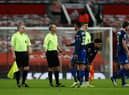 Kayne Ramsay of Southampton interacts with Referee, Mike Dean after the Premier League match between Manchester United and Southampton.