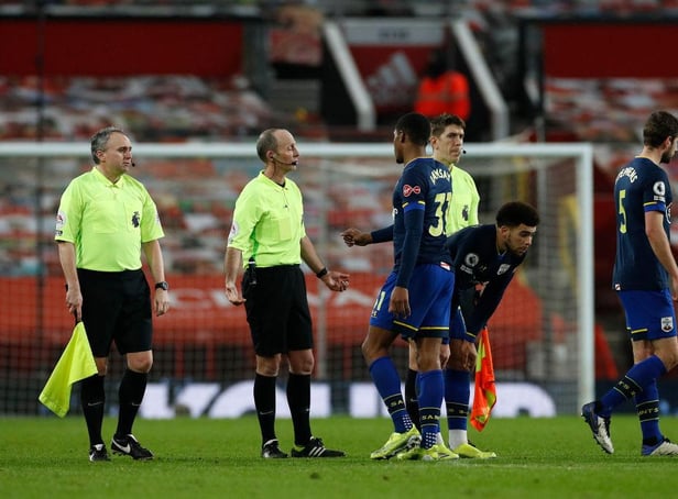 Kayne Ramsay of Southampton interacts with Referee, Mike Dean after the Premier League match between Manchester United and Southampton.