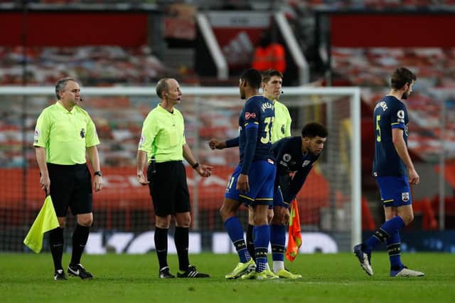 Kayne Ramsay of Southampton interacts with Referee, Mike Dean after the Premier League match between Manchester United and Southampton.