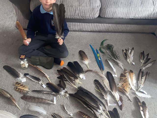 Dylan Barney with some of his feathers.