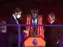 LIVERPOOL, ENGLAND - JULY 22: Richard Masters, Chief Executive of Premier League and Sir Kenny Dalglish, Former Captain and Manager of Liverpool place The Premier League trophy upon a plinth following the Premier League match between Liverpool FC and Chelsea FC at Anfield on July 22, 2020 in Liverpool, England.