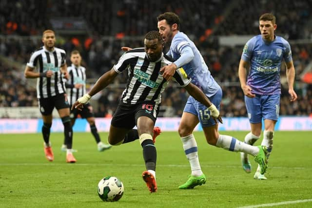 Newcastle player Allan Saint-Maximin is challenged by Adam Smith of Bournemouth during the Carabao Cup Fourth Round match between Newcastle United and AFC Bournemouth at St James' Park on December 20, 2022 in Newcastle upon Tyne, England. (Photo by Stu Forster/Getty Images)