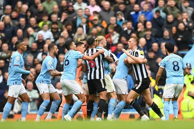 Erling Haaland of Manchester City and Dan Burn of Newcastle United clash during the Premier League match between Manchester City and Newcastle United at Etihad Stadium on March 04, 2023 in Manchester, England. (Photo by Michael Regan/Getty Images)