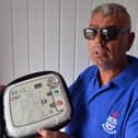 The Red Hackle pub owner Lee Hughes with the AEDs public access defibrillators.