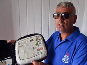 The Red Hackle pub owner Lee Hughes with the AEDs public access defibrillators.