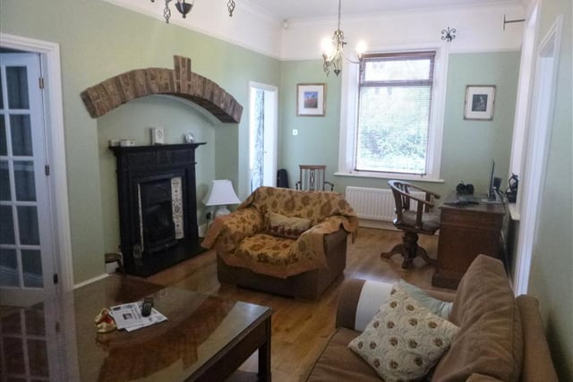 The cosy lounge boasts a fireplace and gas fire. It also benefits from a solid hard wood Oak flooring and two double glazed windows.

Photo: Rightmove