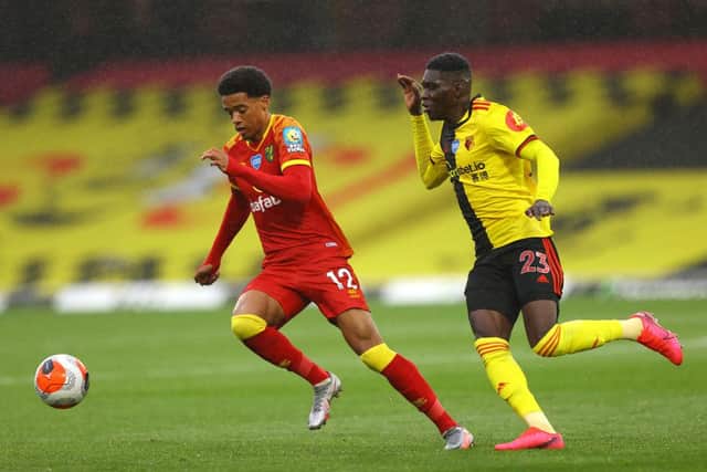 WATFORD, ENGLAND - JULY 07: Jamal Lewis of Norwich City and Ismaila Sarr of Watford battle for the ball during the Premier League match between Watford FC and Norwich City at Vicarage Road on July 07, 2020 in Watford, England.
