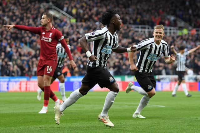 Christian Atsu of Newcastle United celebrates after scoring his team's first goal during the Premier League match between Newcastle United and Liverpool FC at St. James Park on May 04, 2019 in Newcastle upon Tyne, United Kingdom.