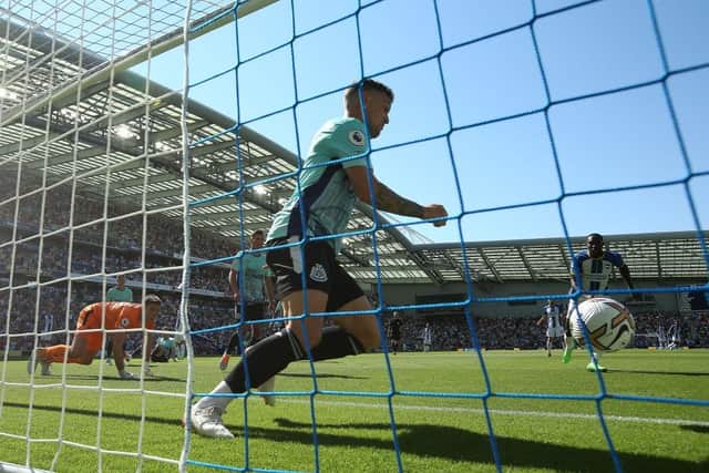 Kieran Trippier of Newcastle United clears the shot of Solly March of Brighton & Hove Albion (Not seen) of the line during the Premier League match between Brighton & Hove Albion and Newcastle United at American Express Community Stadium on August 13, 2022 in Brighton, England. (Photo by Steve Bardens/Getty Images)