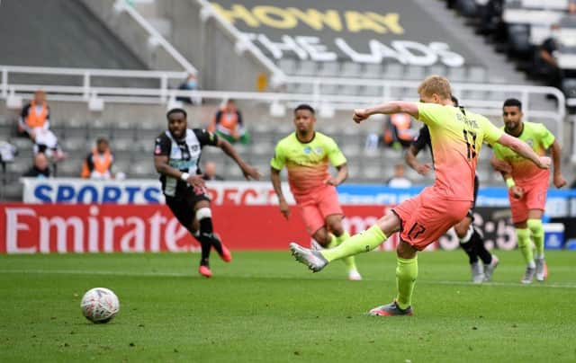Manchester City's Belgian midfielder Kevin De Bruyne (R) shoots to score the opening goal from a penalty during the English FA Cup quarter-final football match between Newcastle United and Manchester City at St James' Park in Newcastle-upon-Tyne, north east England on June 28, 2020.