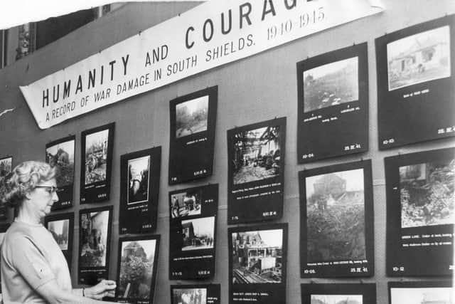 Rose Mary Farrell, of the reference department at South Shields Public Library, hanging photographs of war damage in the town, part of the Amy Flagg exhibition in 1969.