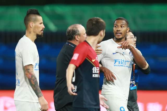 This photo taken on August 20, 2020 shows Dalian Pro's Salomon Rondon (R) being led off by coach Rafael Benitez (partly obscured) and teammate Marek Hamsik as he argues with Shenzhen FC players at the end of their Chinese Super League football match in Dalian, in China's northeast Liaoning province.
