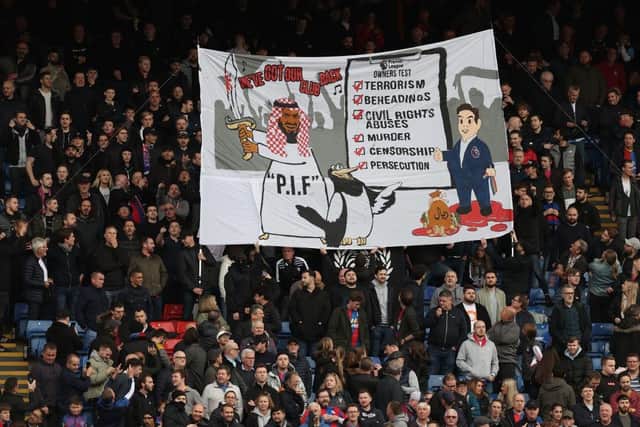 Crystal Palace fans display a banner attacking the Premier League for approving Newcastle’s Saudi-backed takeover seen before the Premier League match between Crystal Palace and Newcastle United at Selhurst Park on October 23, 2021 in London, England. (Photo by Julian Finney/Getty Images)