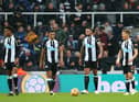 Isaac Hayden, second left, reacts to Manchester City's second goal.