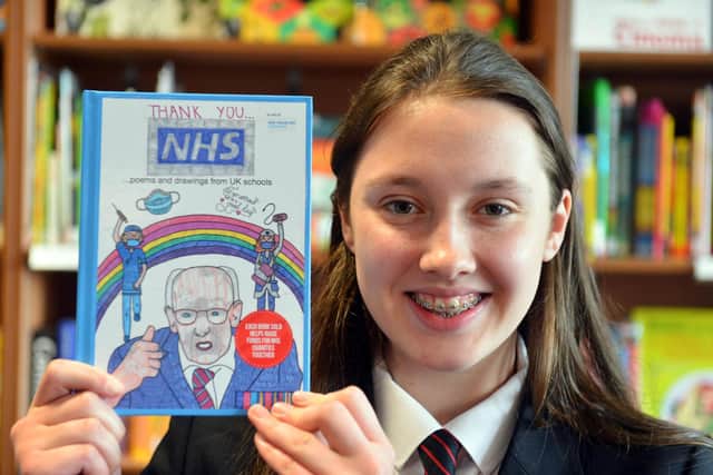 Hebburn Comprehensive School pupil Erin Dunn, 13, with her painting on the front-cover of the "Thank You NHS" book.
